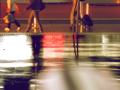 Blurred faces of staff providing reception and security services in a modern building.