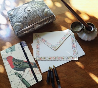 The full Majalis set displayed on a wooden table, including the box, pen, and booklet, inviting to be explored.