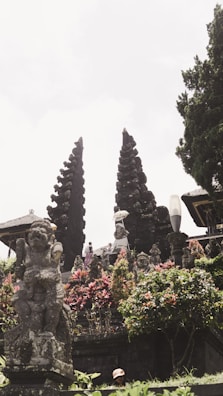 An ancient temple surrounded by lush greenery and flowers.