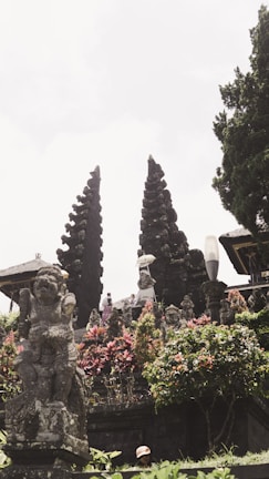 Historic temple ruins surrounded by lush greenery and bright flowers.