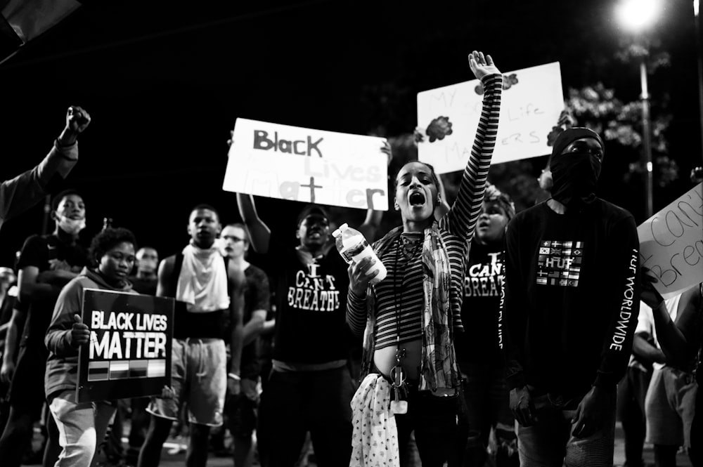 grayscale photo of people standing and smiling