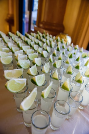 A lively wedding reception with guests enjoying a shot bar setup.