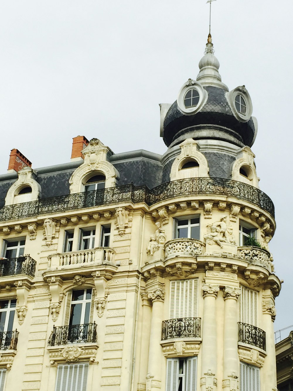 beige and black concrete building under white sky during daytime