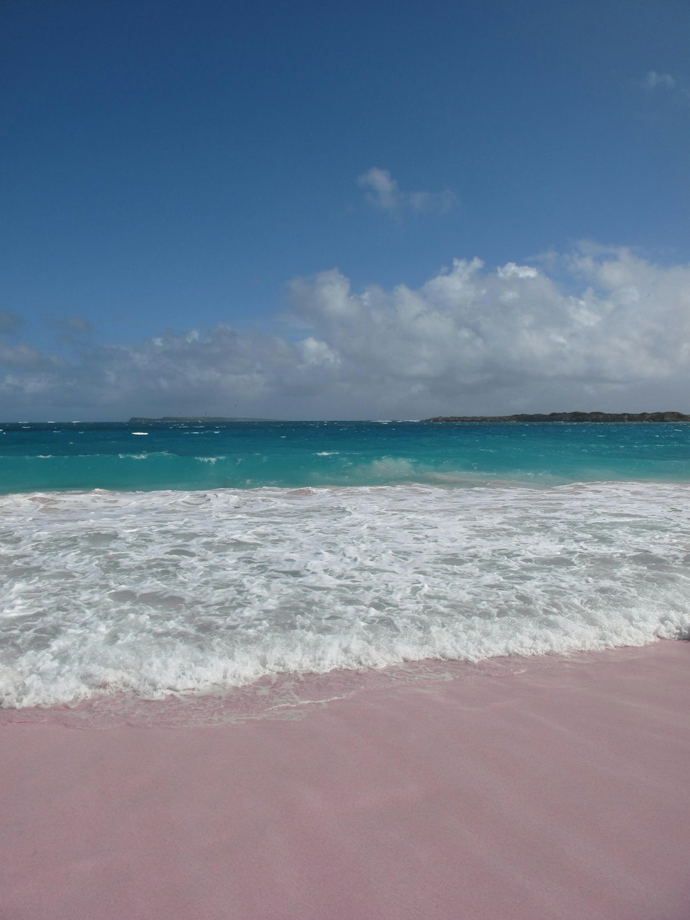 ocean waves crashing on shore during daytime