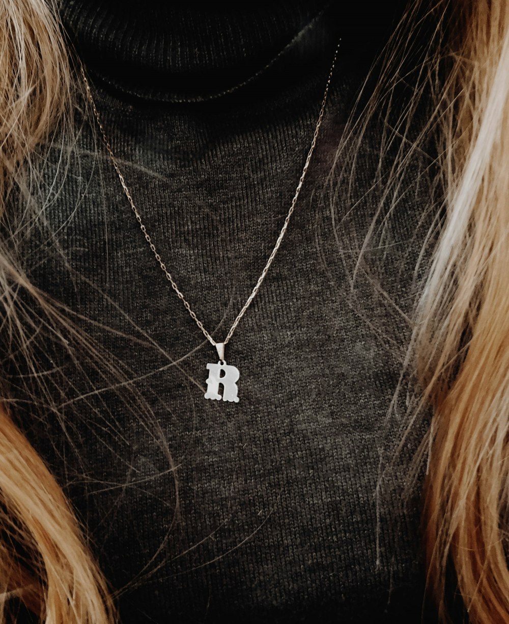 silver heart pendant necklace on womans brown hair