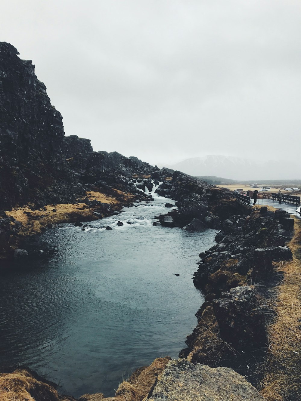 body of water between mountains during daytime