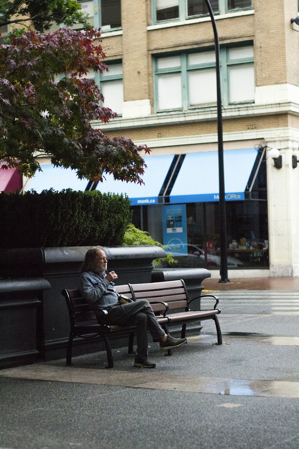 woman in black jacket sitting on black bench