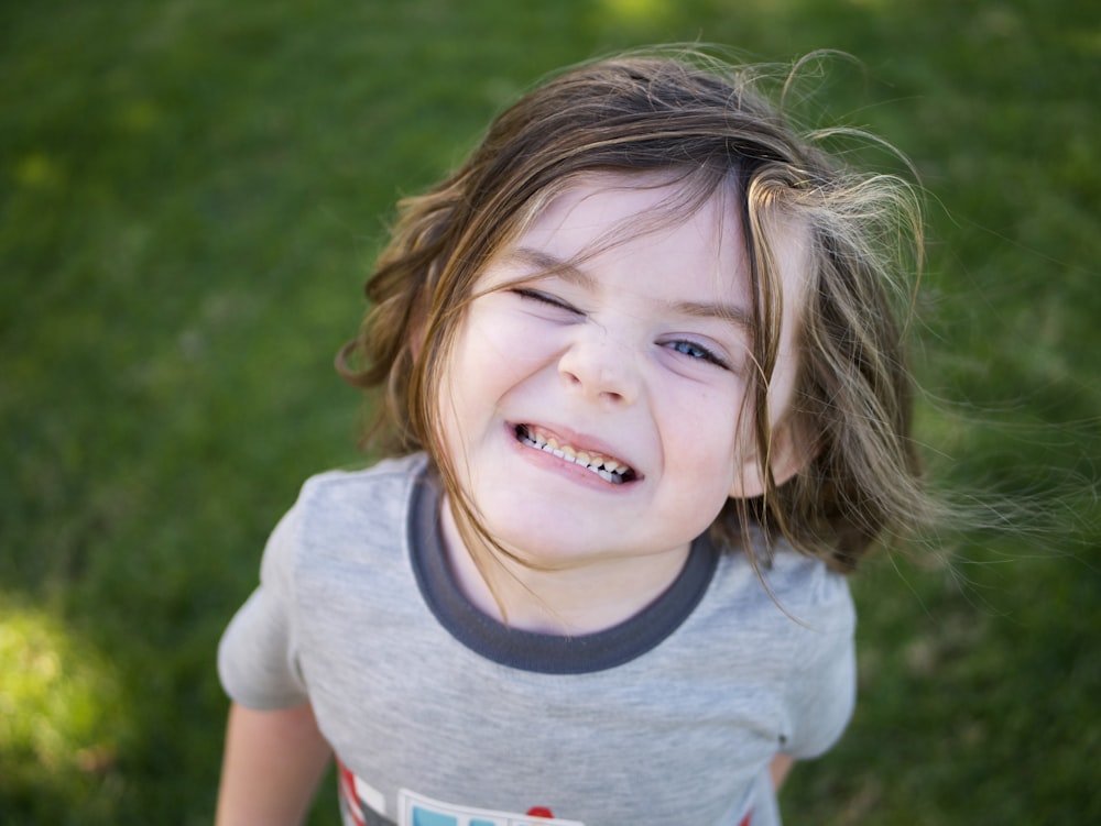 girl in white crew neck t-shirt smiling