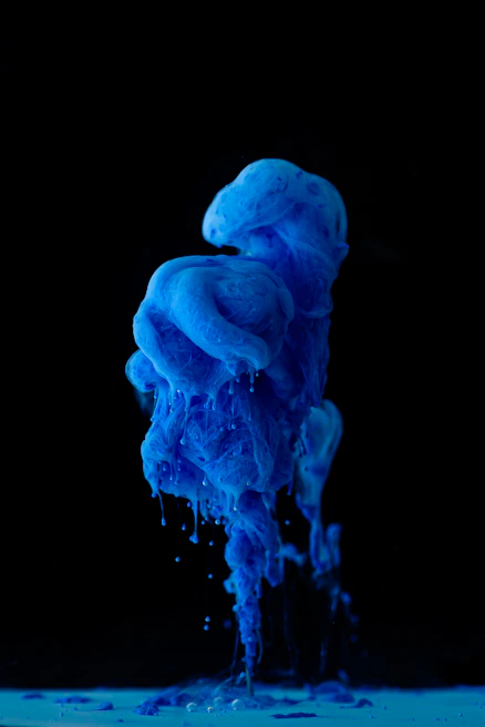 Close-up of a printing process showcasing blue ocean inks being applied to a substrate.