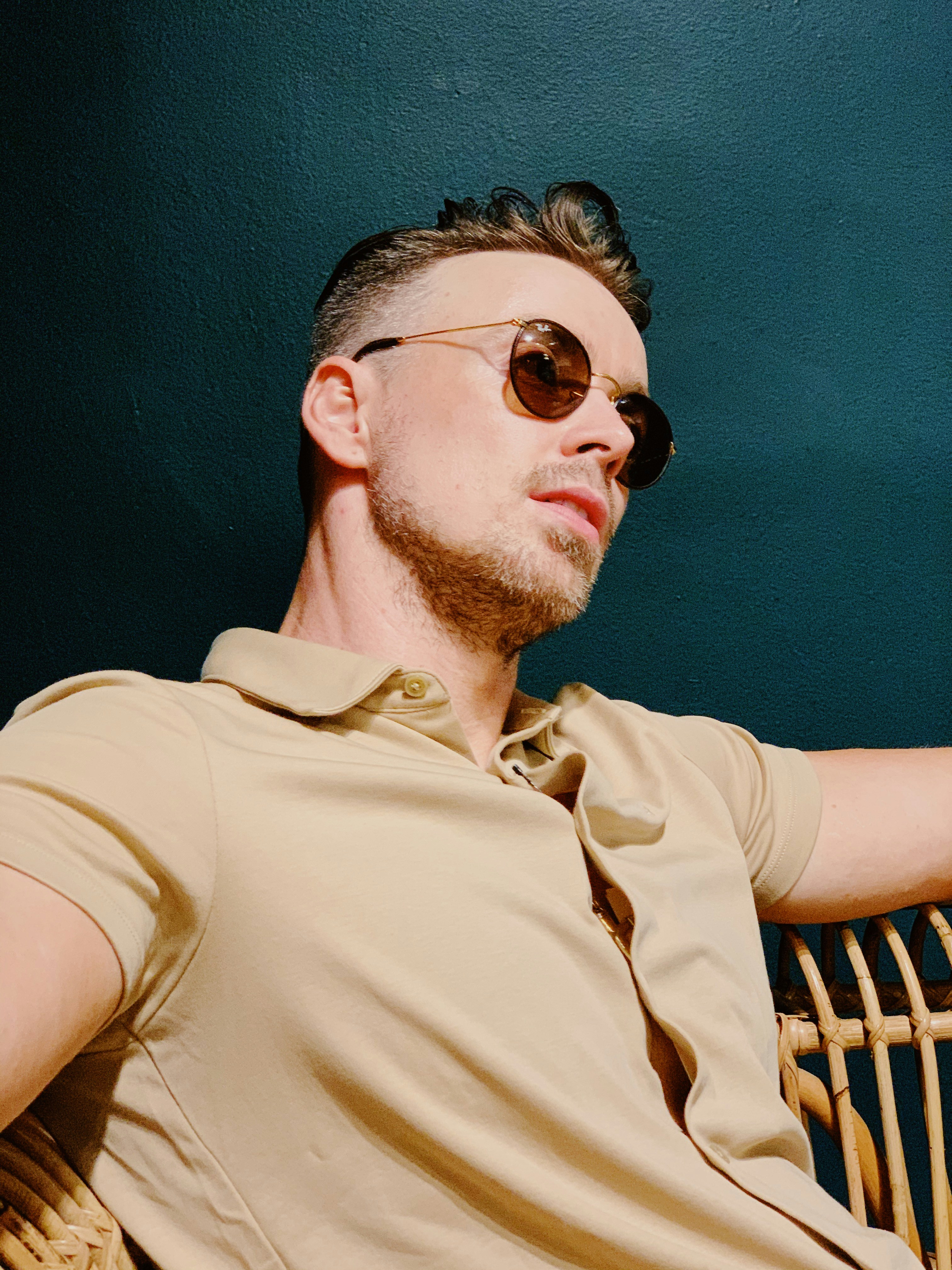 man in brown polo shirt wearing black sunglasses