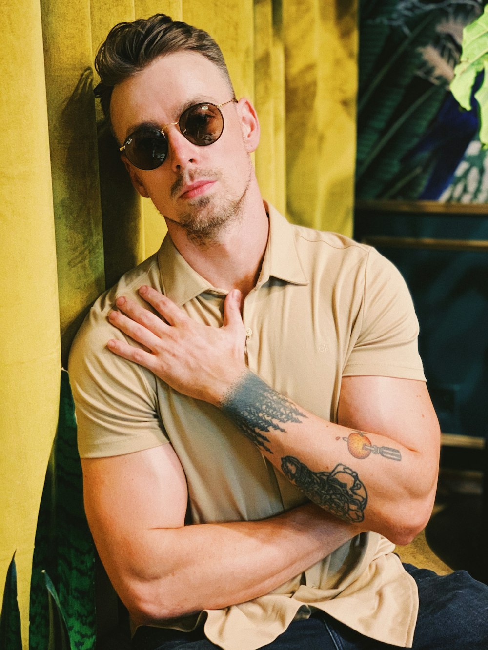 man in brown button up shirt wearing black sunglasses