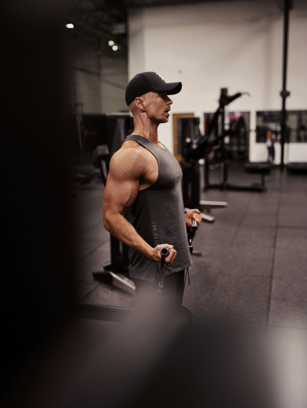 man in black tank top and black cap