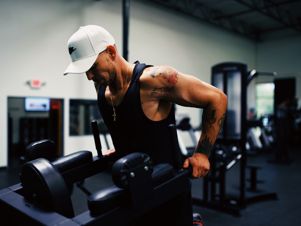 man in black tank top wearing white hard hat