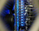 Close-up of fiber optic cables glowing with blue light in a modern data center.