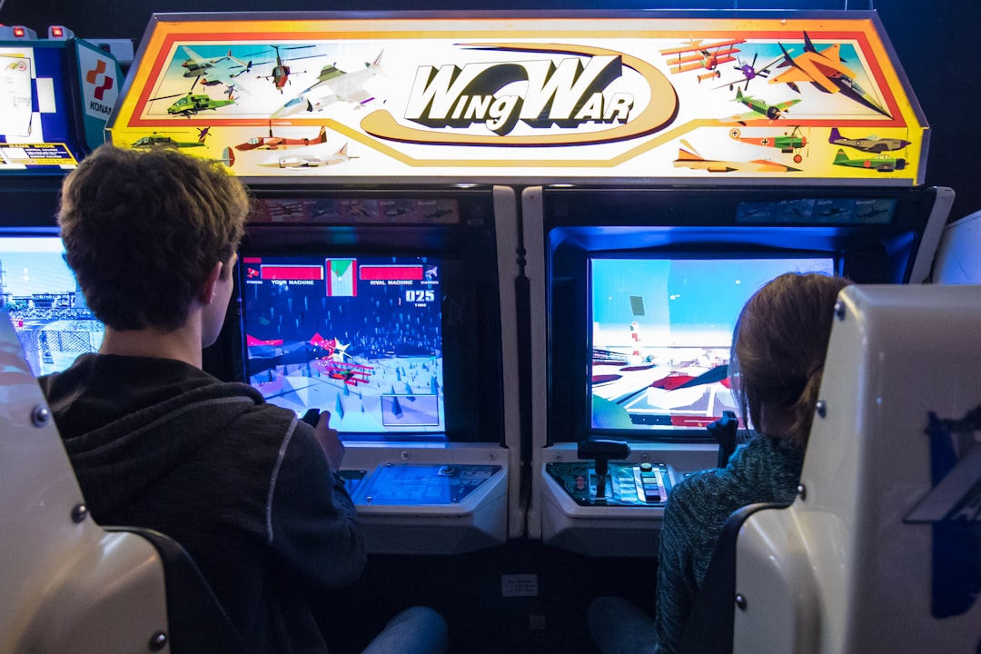 man in black jacket watching on arcade game,