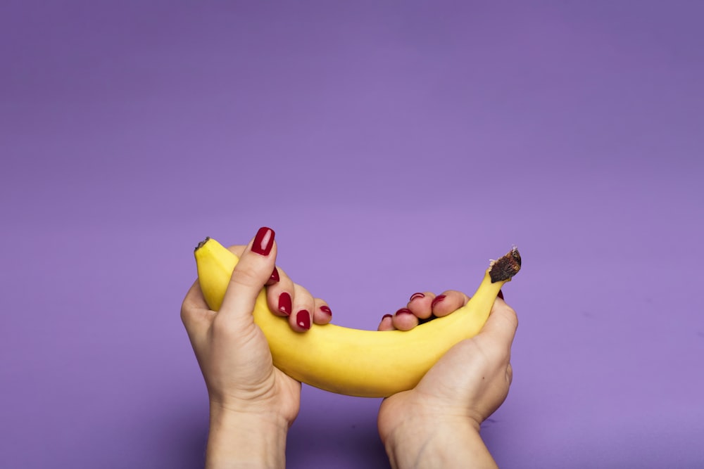 person holding yellow banana fruit