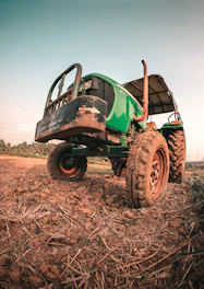 Used tractor parked in a sunny field ready for work