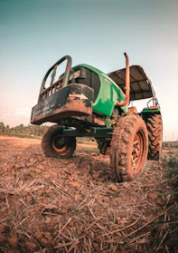 Used tractor parked in a sunny field ready for work