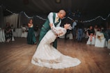 Guests clapping joyfully as the couple shares their first dance