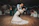 A joyful couple sharing a dance in the stylish black and white interior of One Ten Venue.