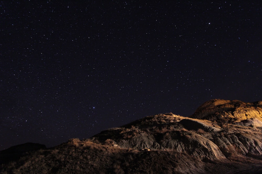 brown mountain under blue sky during night time