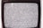 A close-up view of an old television screen displaying static noise. The screen is filled with a pattern of black and white dots and spots, typical of a signal loss or disturbance. The television set has a vintage design with a black frame.