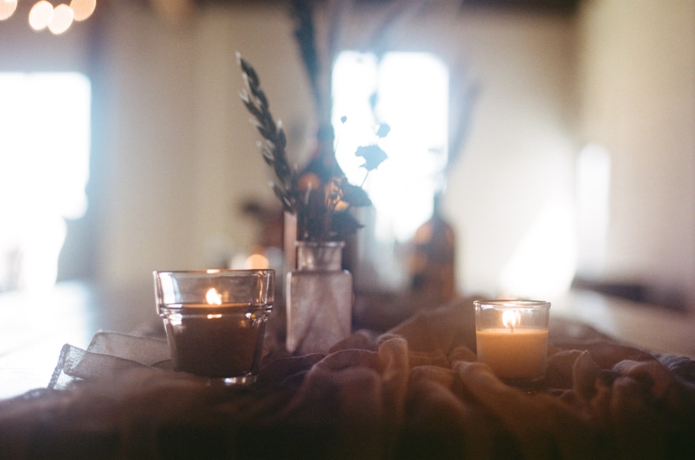 a couple of candles sitting on top of a table