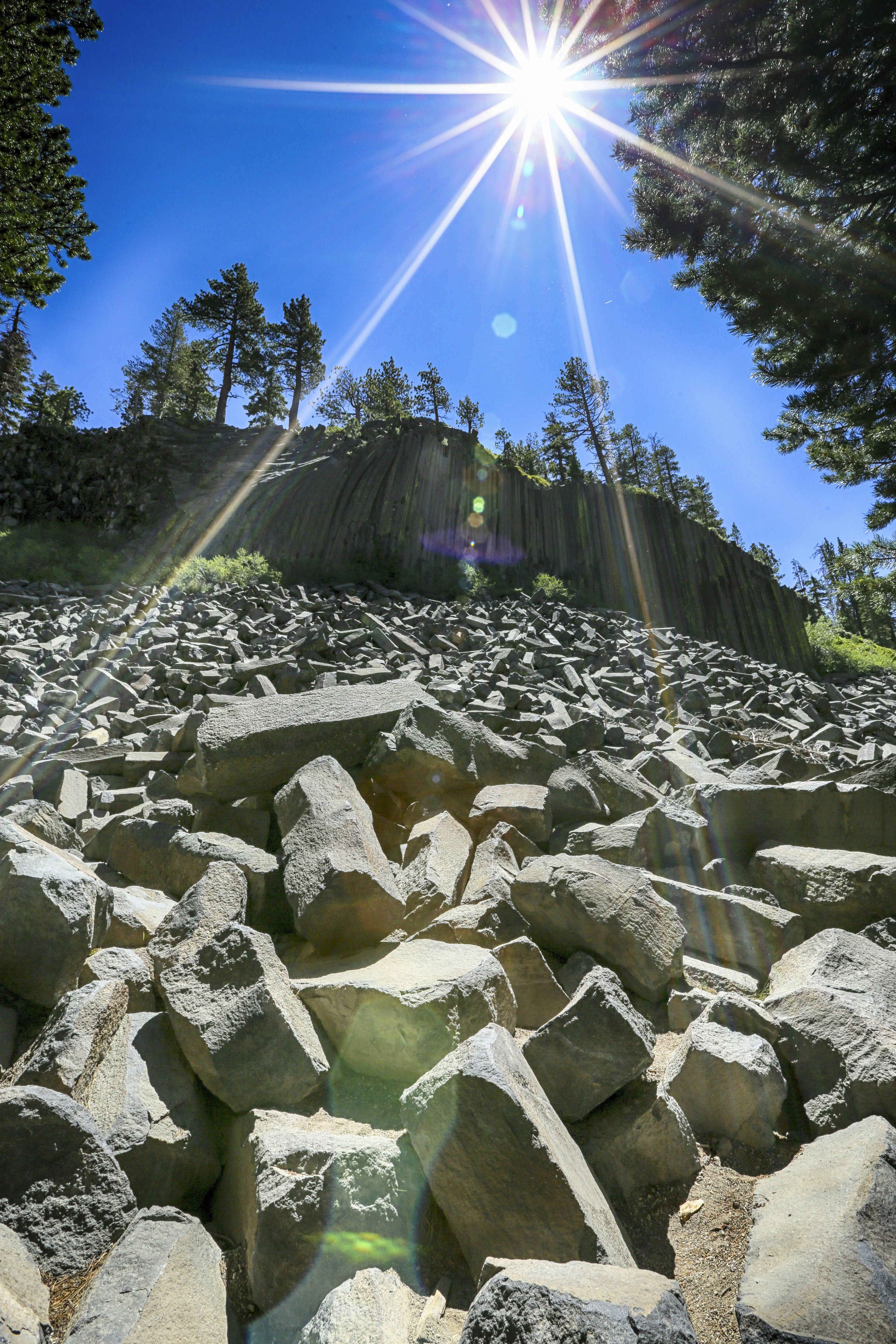 the sun shines brightly over a rocky area