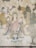 A traditional Asian-style painting featuring three figures adorned in ornate robes. The central figure appears divine or enlightened, holding one hand in a gesture of teaching. Surrounding them are swirling clouds, trees, and architectural elements suggestive of a heavenly realm. There is also an inscription in a vertical column, adding to the spiritual or historical context.