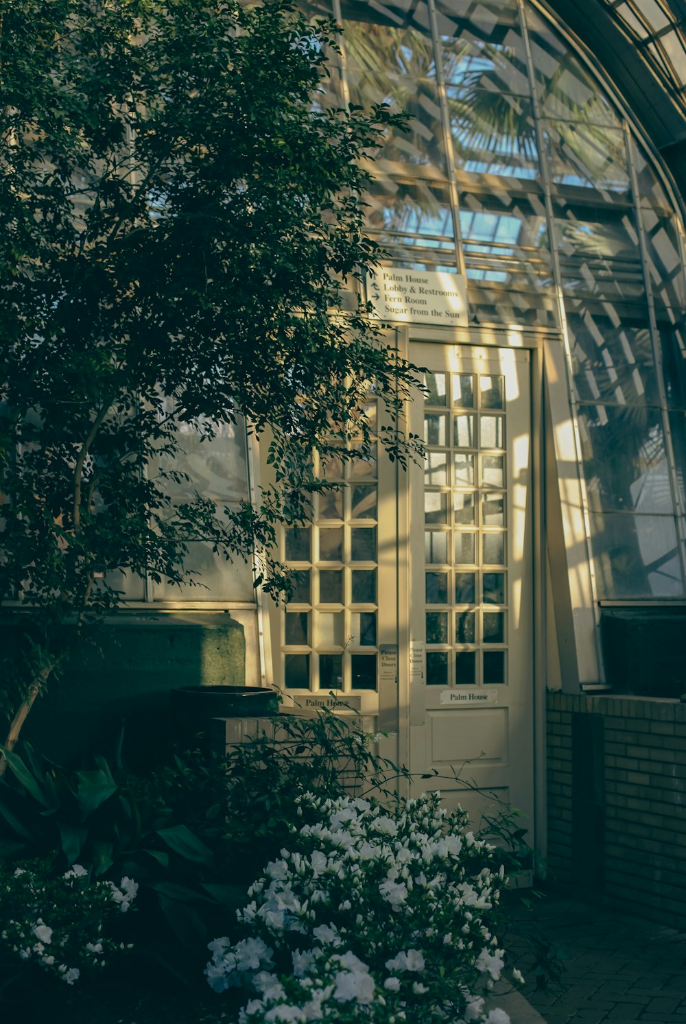 a building that has a bunch of flowers in front of it