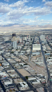 A researcher reviewing climate data charts with a backdrop of desert and city skyline.