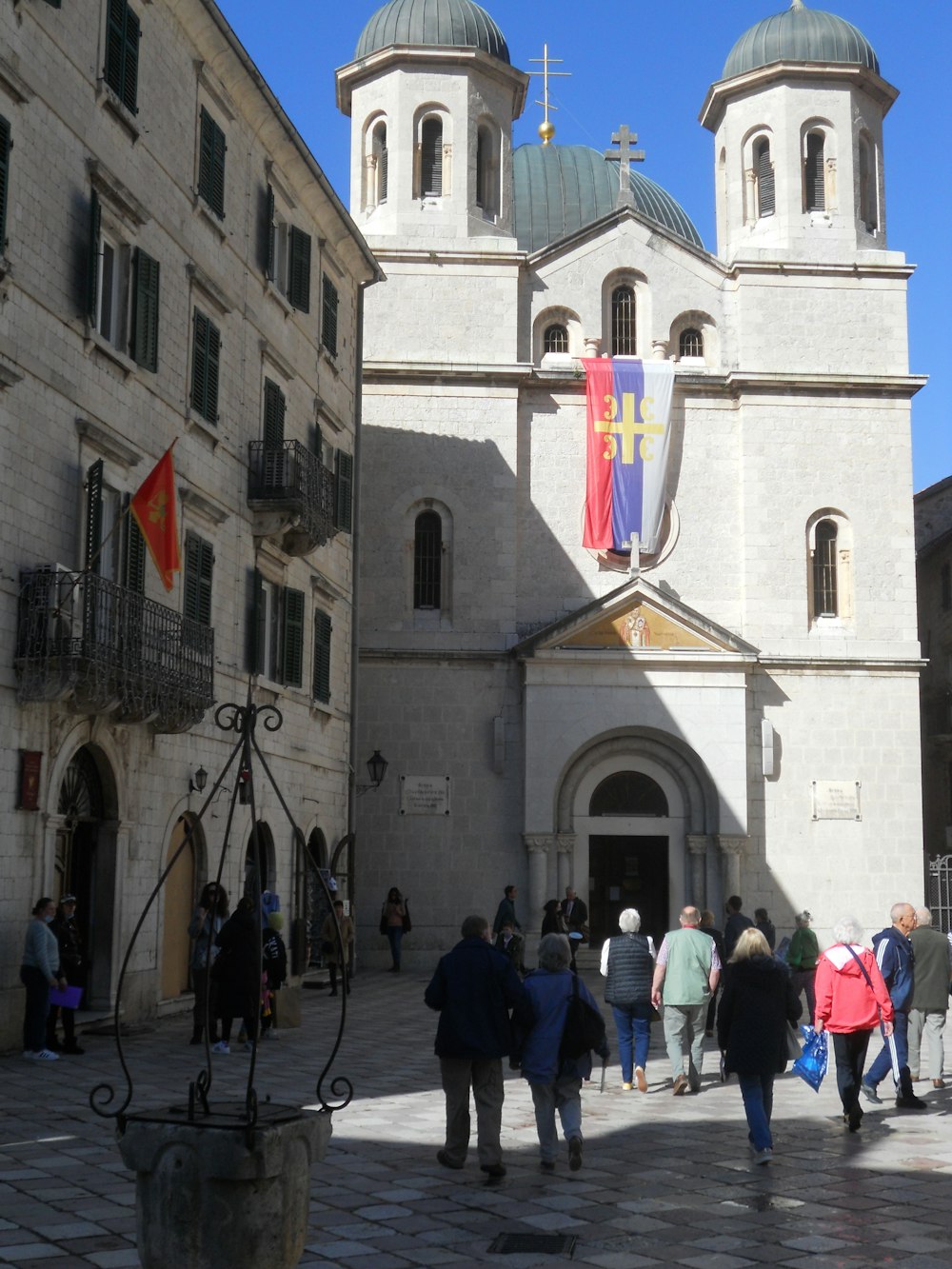 a group of people walking in front of a church
