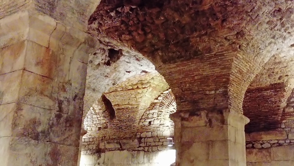 a hallway in an old building with stone walls