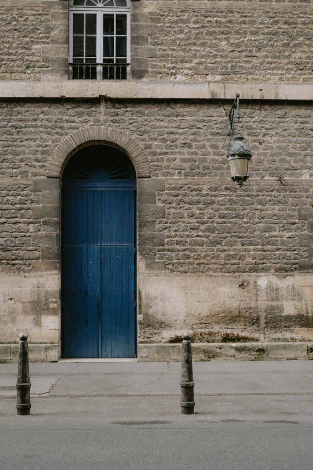 a blue door is in front of a brick building