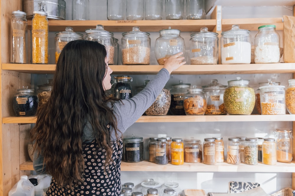 a person holding a jar of food