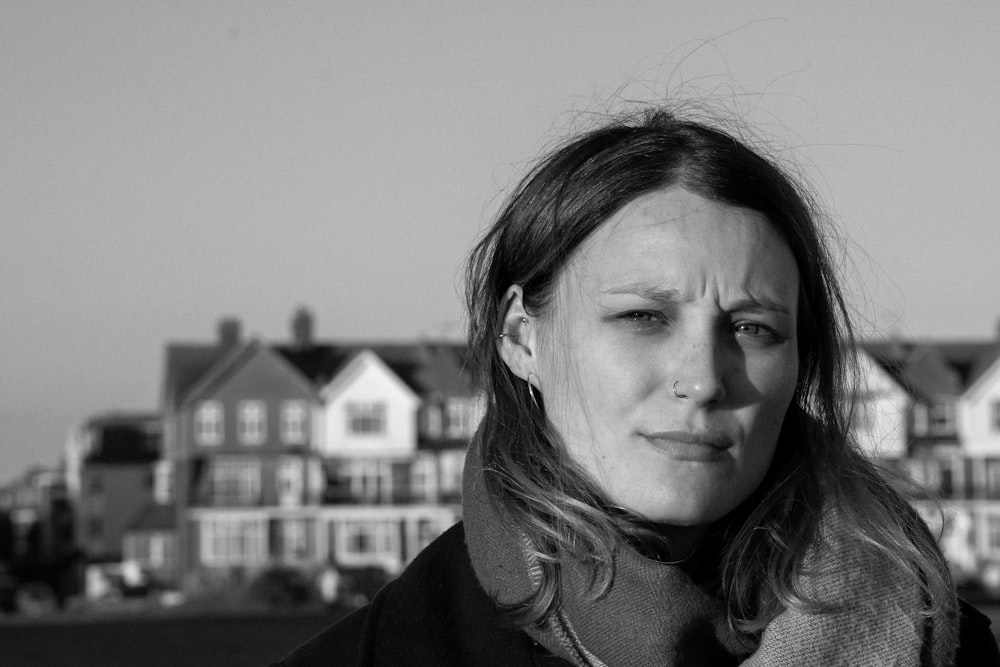 a woman standing in front of a row of houses