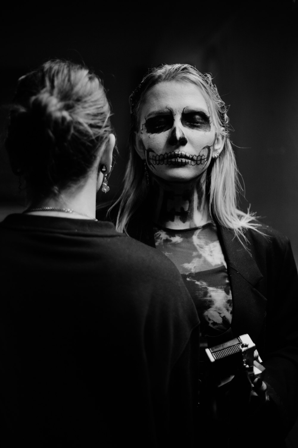 a woman with makeup painted to look like a skeleton