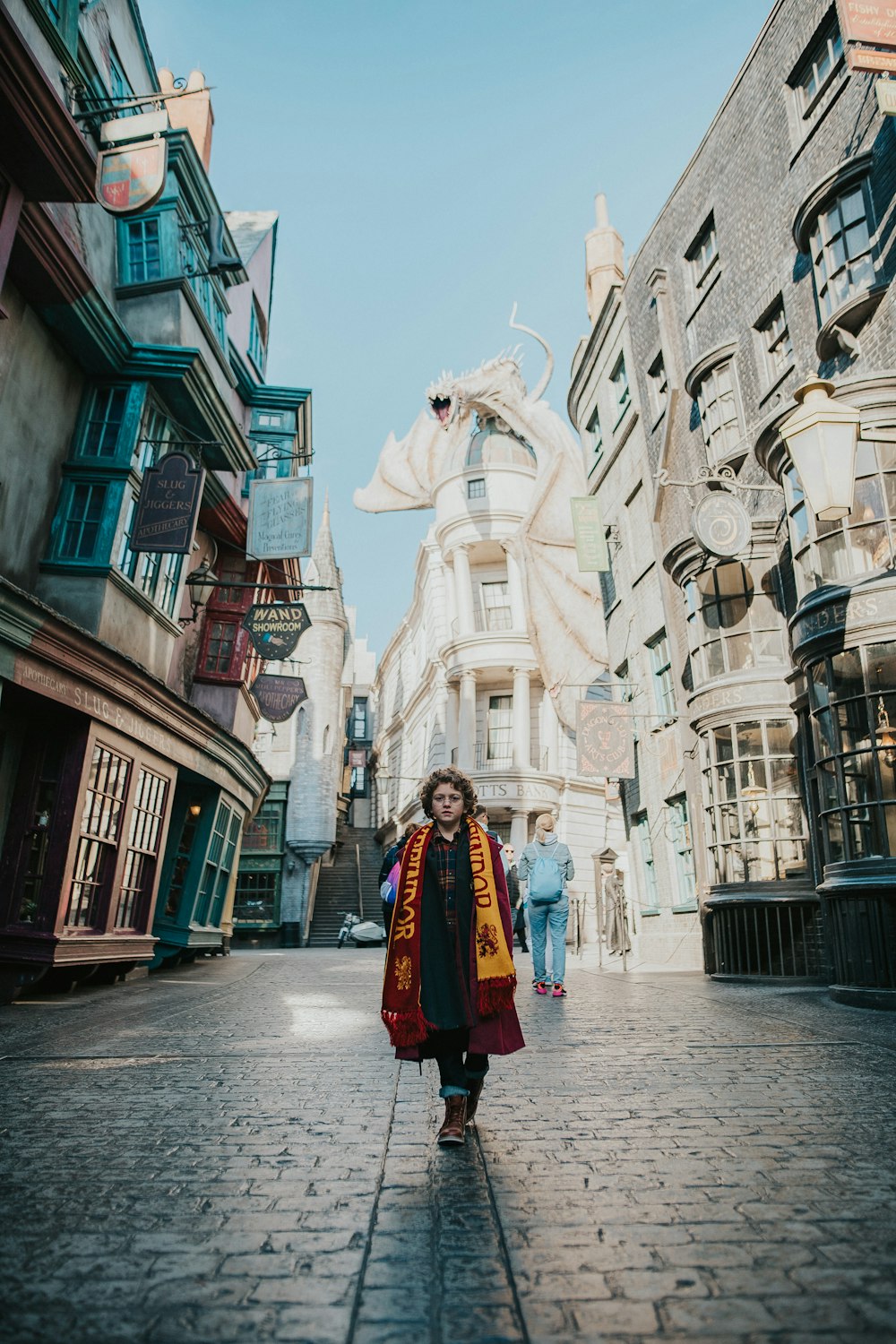 a woman walking down a street in a city