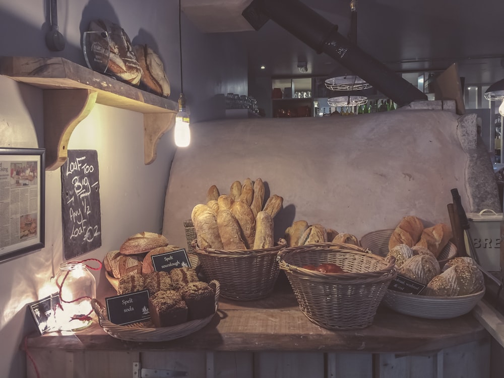 breads in brown wicker basket on top of brown wooden table