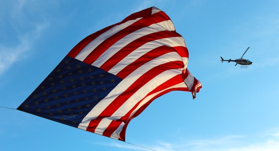 USA flag and helicopter during daytime