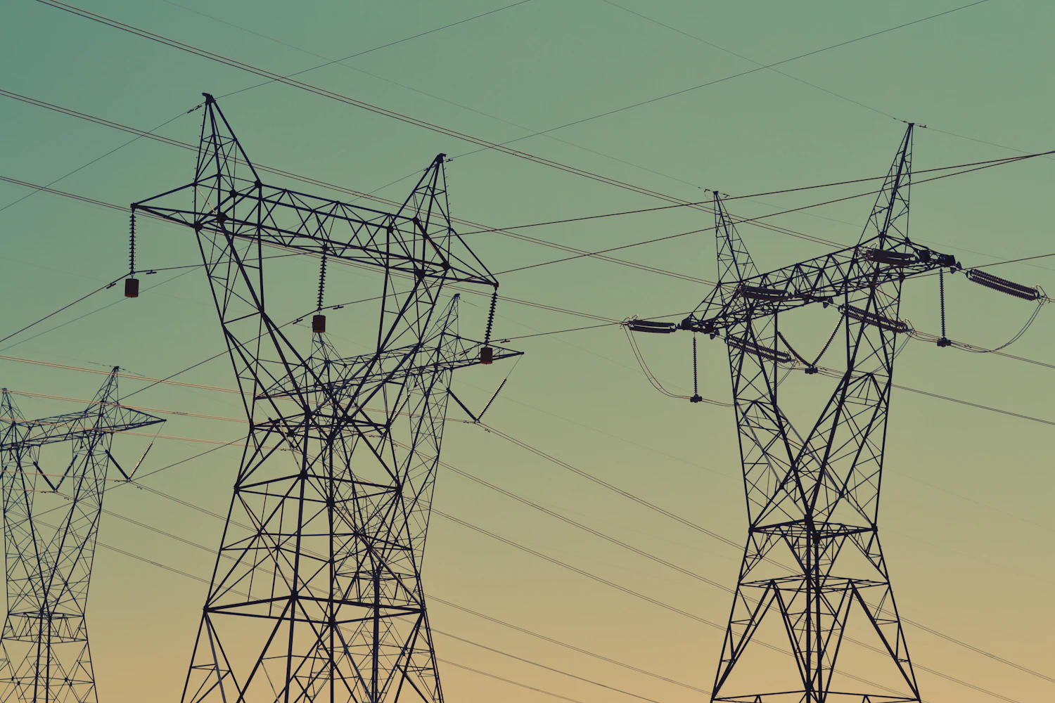 High-voltage transmission towers at dusk