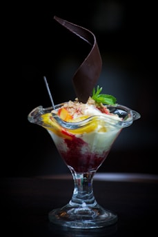 A vibrant sundae topped with fresh fruit and festive decorations reflecting seasonal themes.