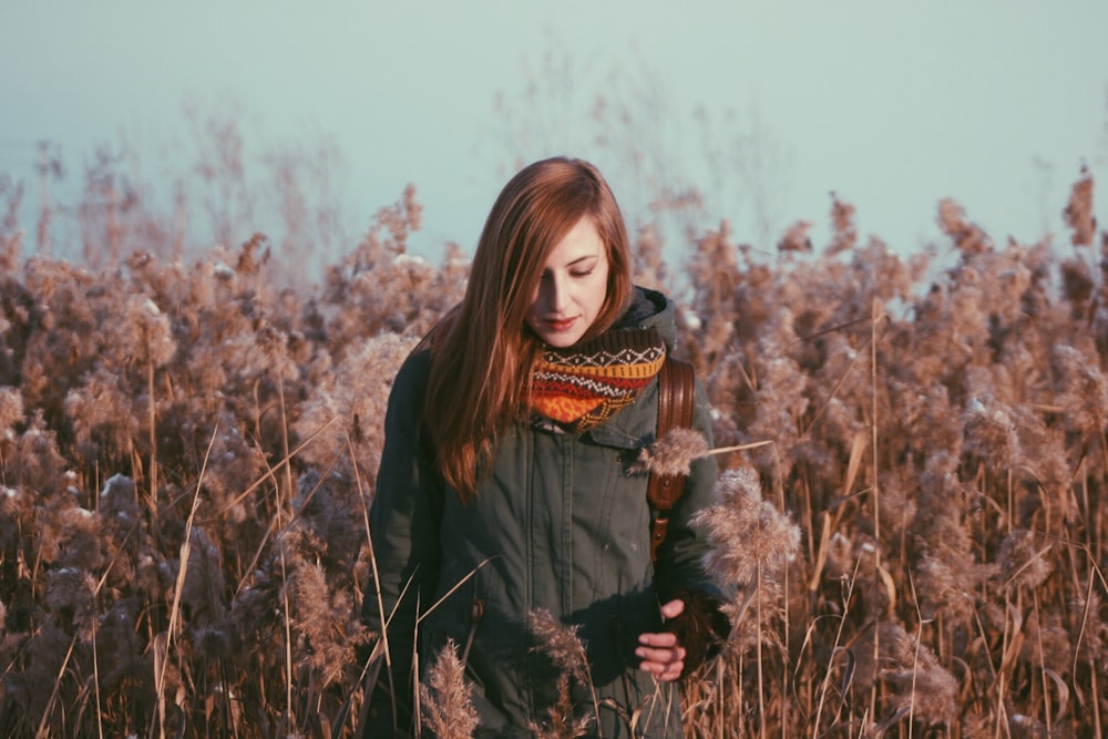 woman standing near grey flowers