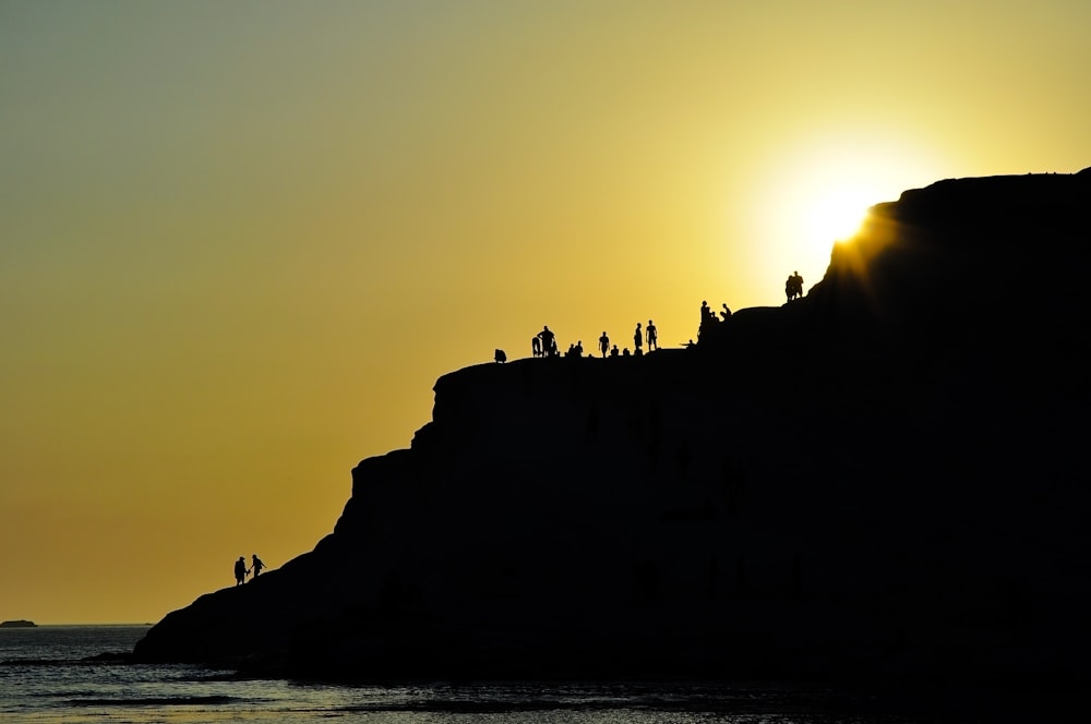 silhouette of group of people on hills