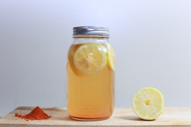 clear glass mason jar on brown surface