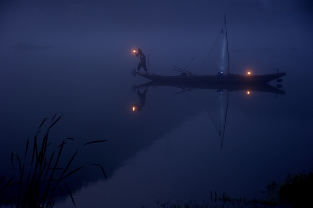 person on boat holding lantern