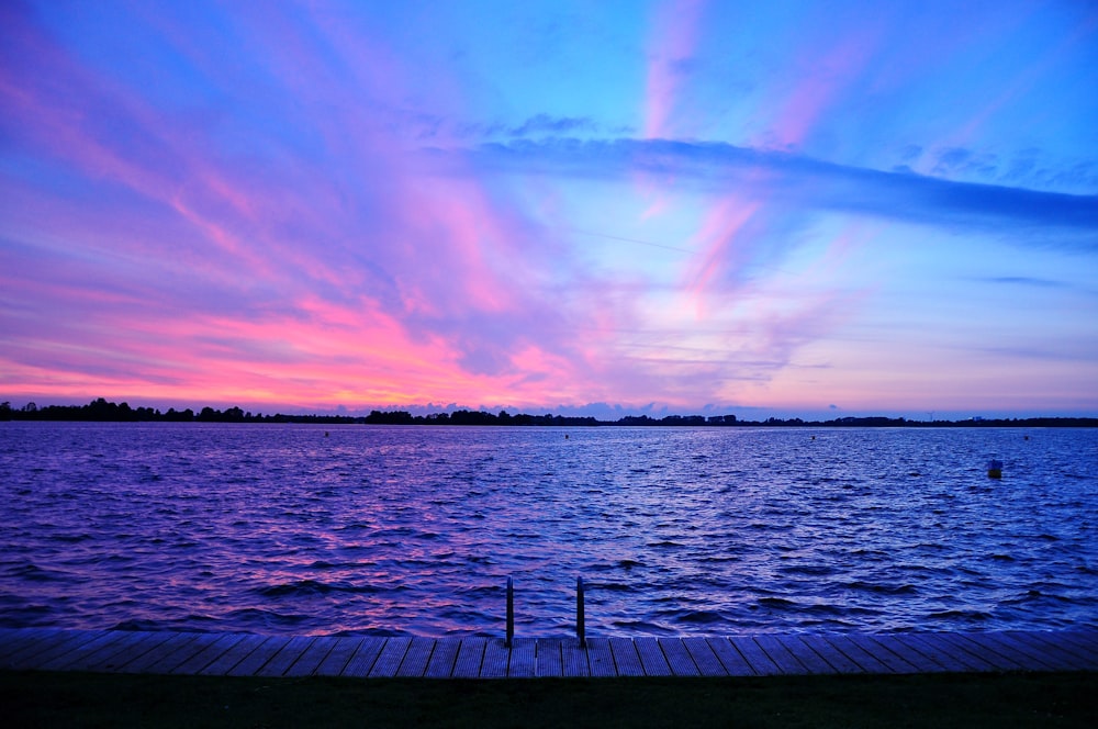 Tranquil red and pink sunset over water photo by davide Tranquil red and pink sunset over water photo by davide