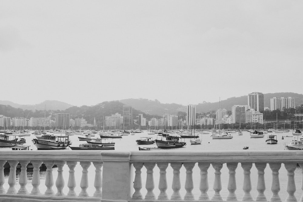 grayscale photo of boats on body of water