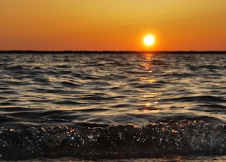 body of water wave photo during golden time