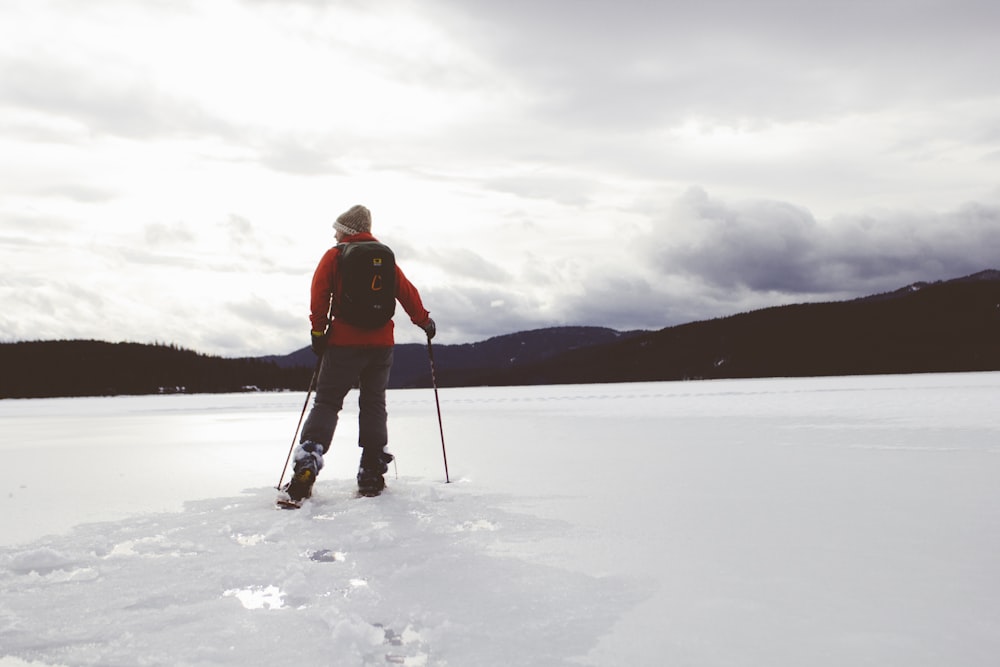 man standing on snow covered surface